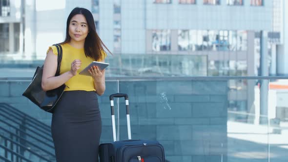 Asian Female Using Touchpad During Business Travel