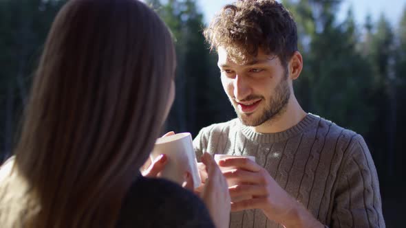 Couple drinking from mugs