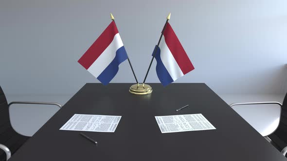 Flags of the Netherlands and Papers on the Table