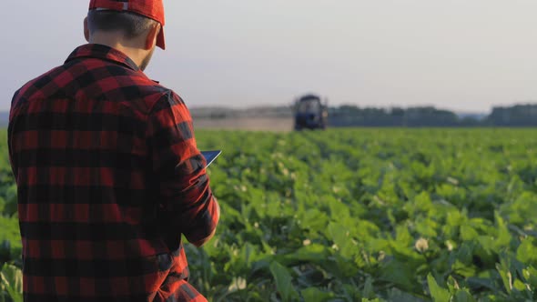 Farmer Using Digital Tablet Computer in Cultivated Field