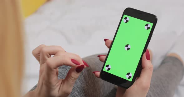 Female Typing on the Green Chroma Key Screen on Smartphone Device with Fingers