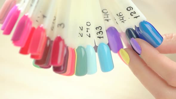 Slow Motion Hand Choosing Nail Samples.