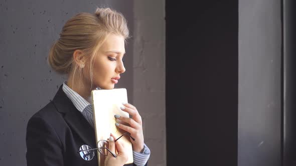 Portrait of a Charming Young Business Lady in a Coffee Shop with a Tablet in Her Hands