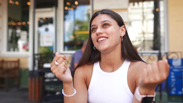 Modern Woman Blogger Leading a Live Broadcast in a Street Cafe