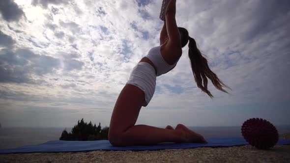 Well Looking Middle Aged Sporty Woman with Long Hair Fitness Instructor in White Sportswear Doing