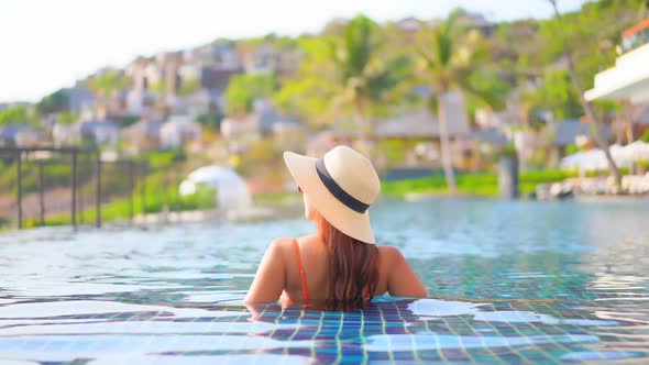 Young asian woman enjoy around outdoor swimming pool for leisure