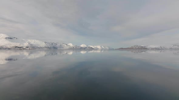 Snowy Mountains On The Horizon Of Daafjord Mirroring Fjord Water