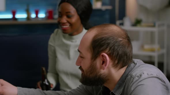 Mixed Race Friends Cheering Bottles of Beer Spending Time Together