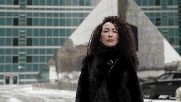 Extravagant Female City Dweller on Street at Winter Long Curly Hair and Tattoos Brows