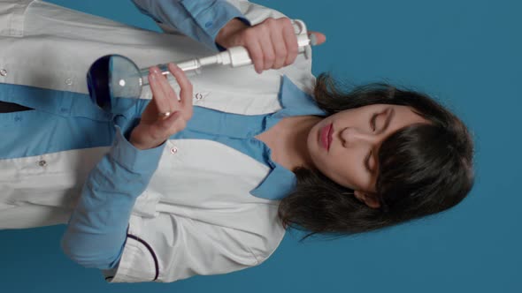 Vertical Video Woman Scientist Using Micro Pipette to Drip Liquid in Beaker
