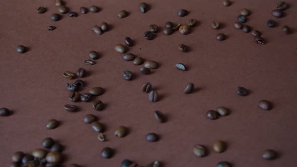 Fragrant roasted coffee beans fall on the table