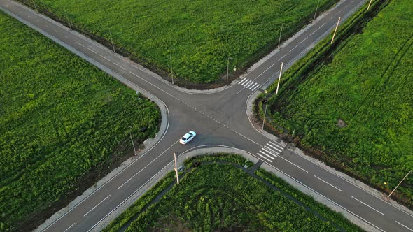 A White Car Passes Right at the Intersection