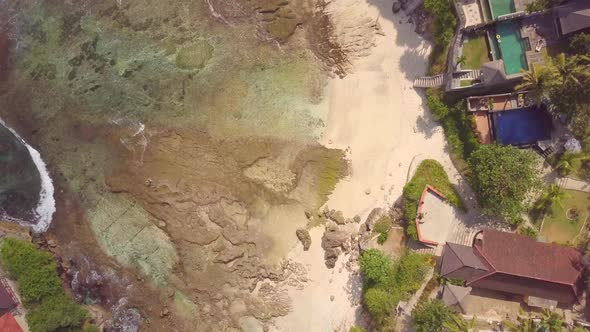 Aerial drone view of the beach at Mahana Point, Bali, Indonesia.