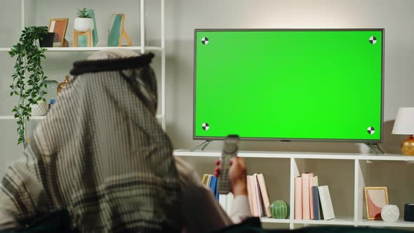 Middle Eastern Man Watching Tv with Chroma Key Closeup