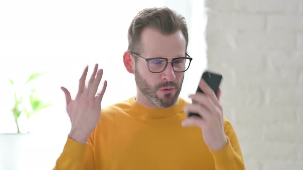 Portrait of Man Talking Angrily on Smartphone