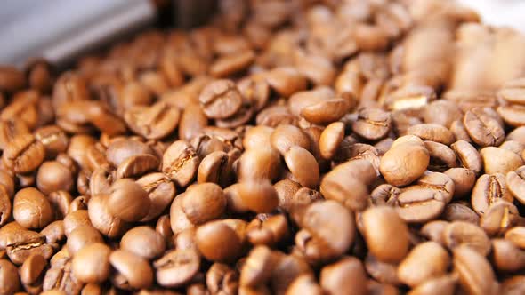 Macro Slow Motion Roasted Coffee Grains Fall Into Box