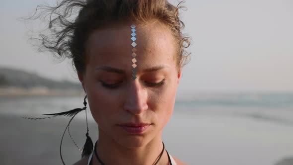 Portrait of Young Woman with Indian Bindi Looking To Camera 