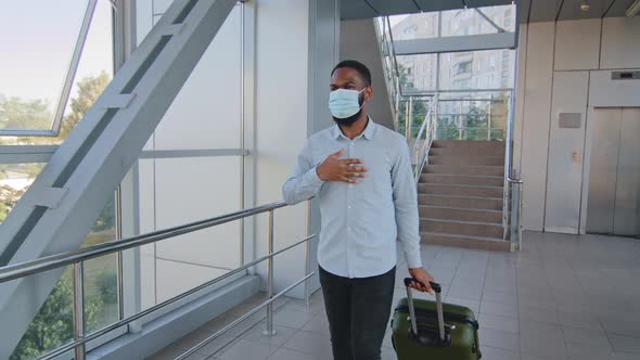 African American Businessman Investor Man in Medical Mask Arrives in New Country at Airport Terminal