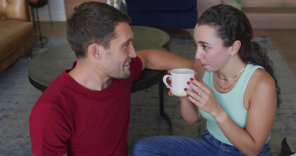 Happy caucasian couple in love drinking coffee and kissing