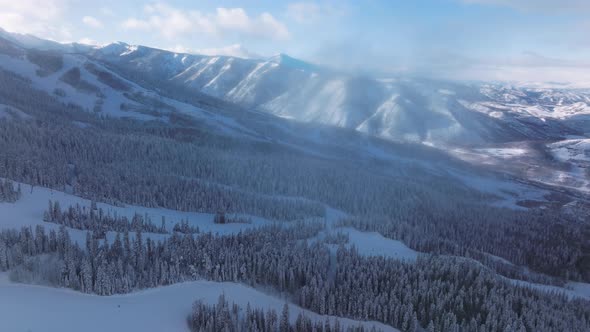 Drone Footage of the Vivid Blue Skyline Above Mountain Peaks Covered in Snow