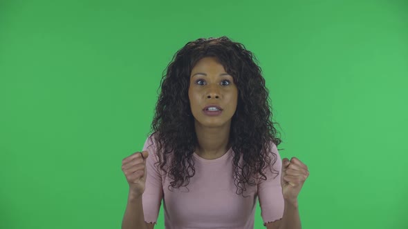 Portrait of Beautiful African American Young Woman Is Looking at the Camera with Excitement, Then