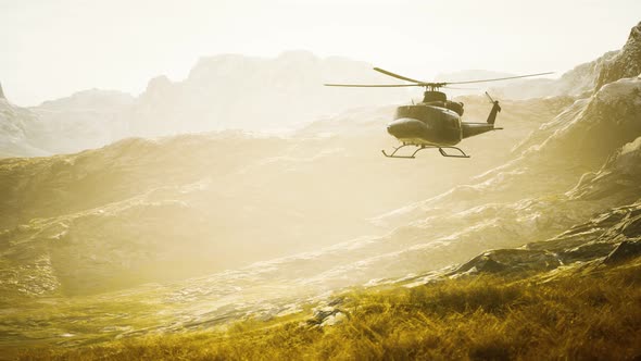 Slow Motion Vietnam War Era Helicopter in Mountains