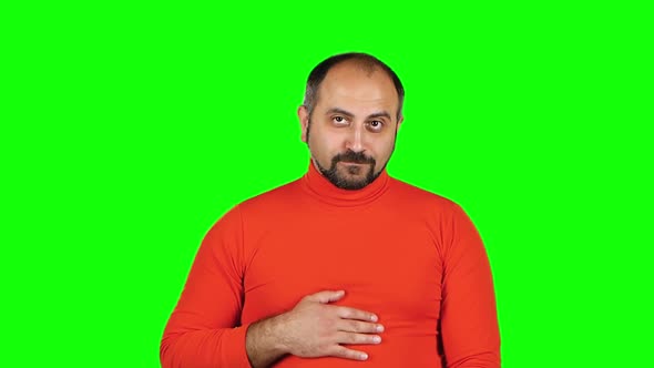 Puffy Guy Sitting and Proposes To Go with Him at Party, Then Asks To Call Him. Green Screen. Slow