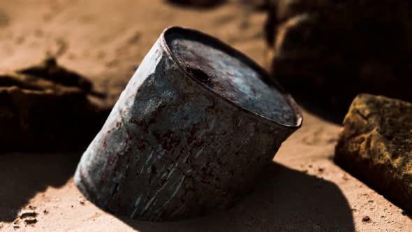 Rusty Metal Oil Barrel on Sand Beach