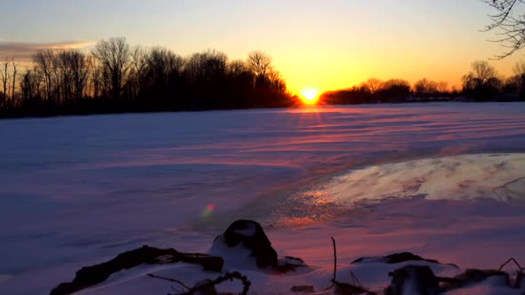 Sunset over frozen river