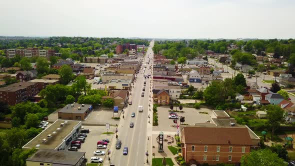 Drone flying over a busy street in a small town.