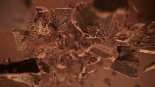 Super Slow Motion Detail Shot of Raw Chocolate Chunks Flying Towards Camera at 1000Fps