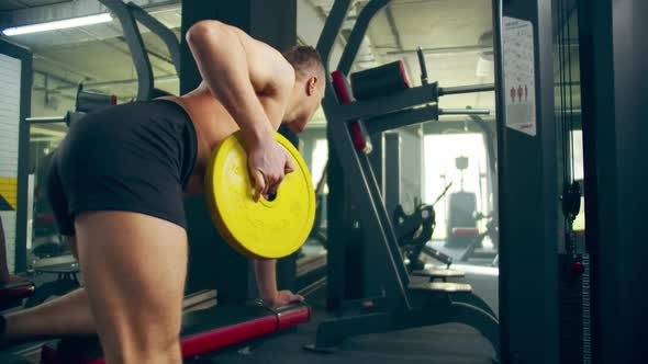 Man Athlete Bent-over Dumpbell Rows Exercise in Gym Hard Working