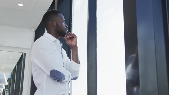 Young man looking through the window