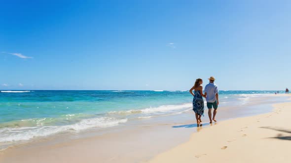 Mature couple walking on beach