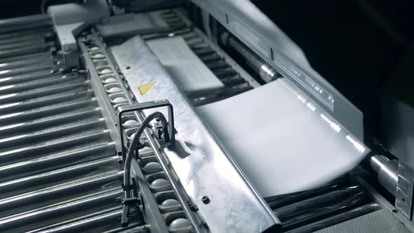 Printing Conveyor with Paper Pages Getting Relocated By It