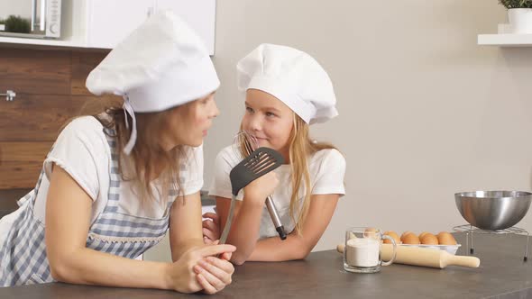 Thoughtful Woman and Daughter Dream About Baking