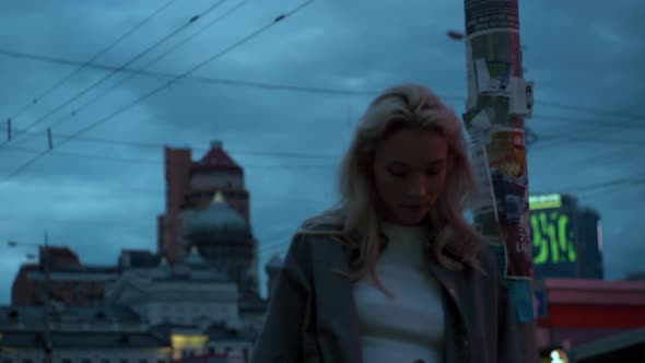Girl in Evening City Standing Near Urban Landscape Street Lights