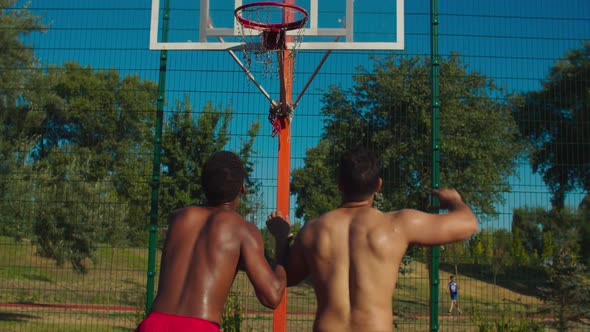 Basketball Players Fighting for Rebound on Court