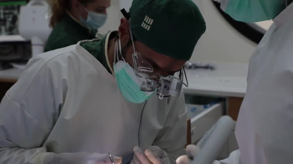 Focused dentist treating teeth of patient in clinic