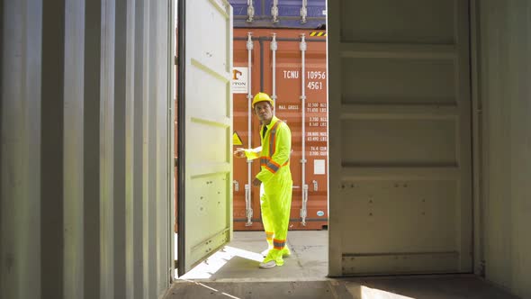 Logistic worker engineer man working in cargo container warehouse industry factory site