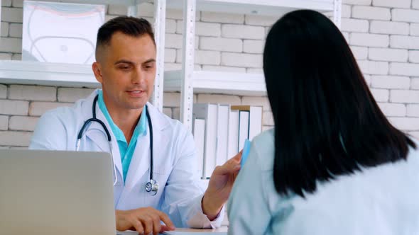 Doctor in Professional Uniform Examining Patient at Hospital