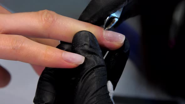 Skilled Beautician Removes Cuticle From Woman Fingernails