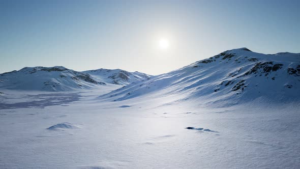 Aerial Landscape of Snowy Mountains and Icy Shores in Antarctica