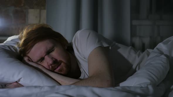 Uncomfortable Redhead Beard Man Sleeping in Bed at Night Restlessness