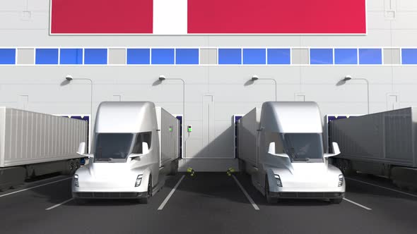 Electric Trucks at Warehouse Loading Dock with Flag of DENMARK