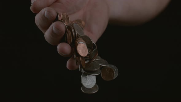 Hand dropping coins in slow motion; shot on Phantom Flex 4K at 1000 fps