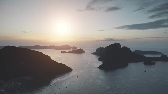 Sunrise Silhouette of Mountain Island at Sea Port Town
