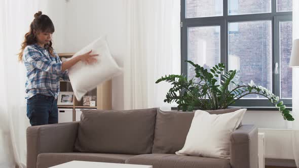 Asian Woman Arranging Sofa Cushions at Home 49