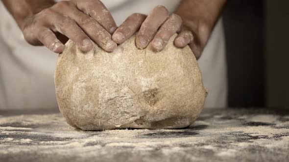 Baker's hands kneading bread dough