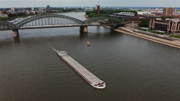 A Large Ferry Floats Along the Rhine River Through Historic Center of Cologne